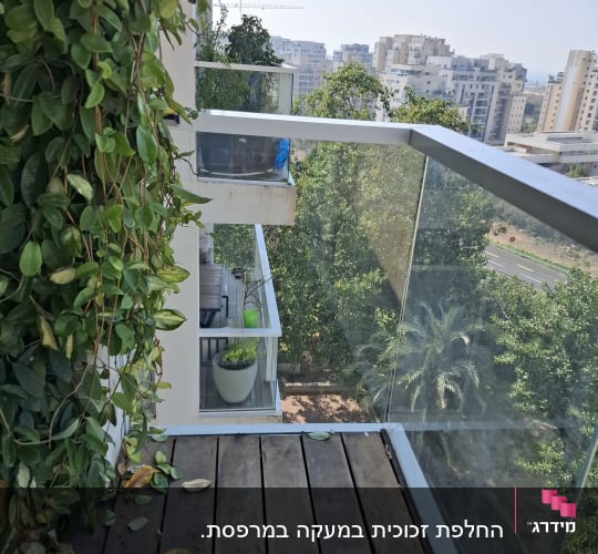 מעקה זכוכית במרפסת עם נוף עירוני